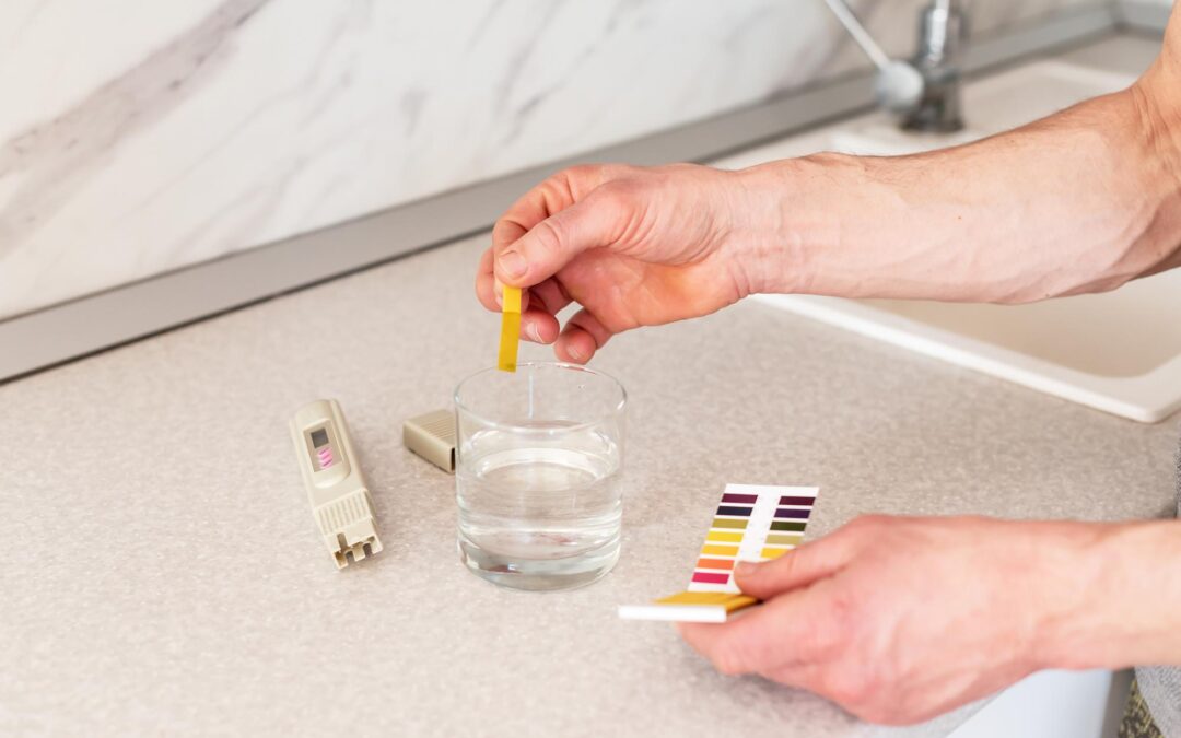 checking-purity-water-home-male-hands-glass-water-quality-tester-universal-litmus-ph-tester-with-color-scale-measuring-characteristics-drinking-water